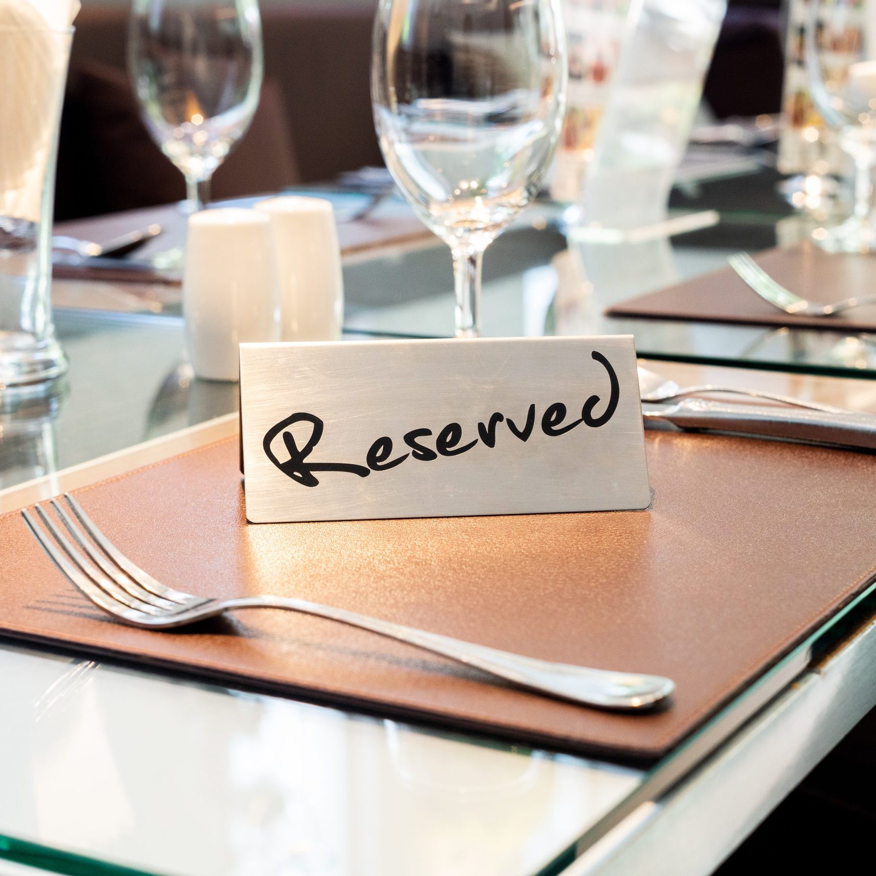 Reserved,Metal,Plate,On,The,Table,With,Blurry,Background.,Reservation